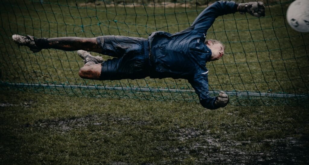 Goalkeeper diving full stretch at the near post