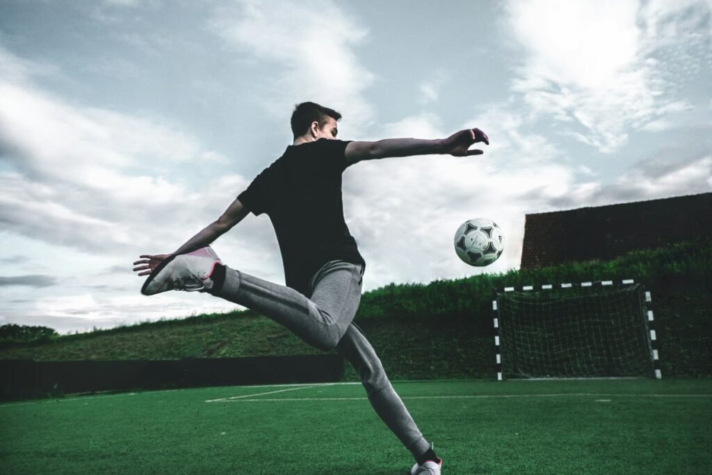 Striker volleying a ball toward goal